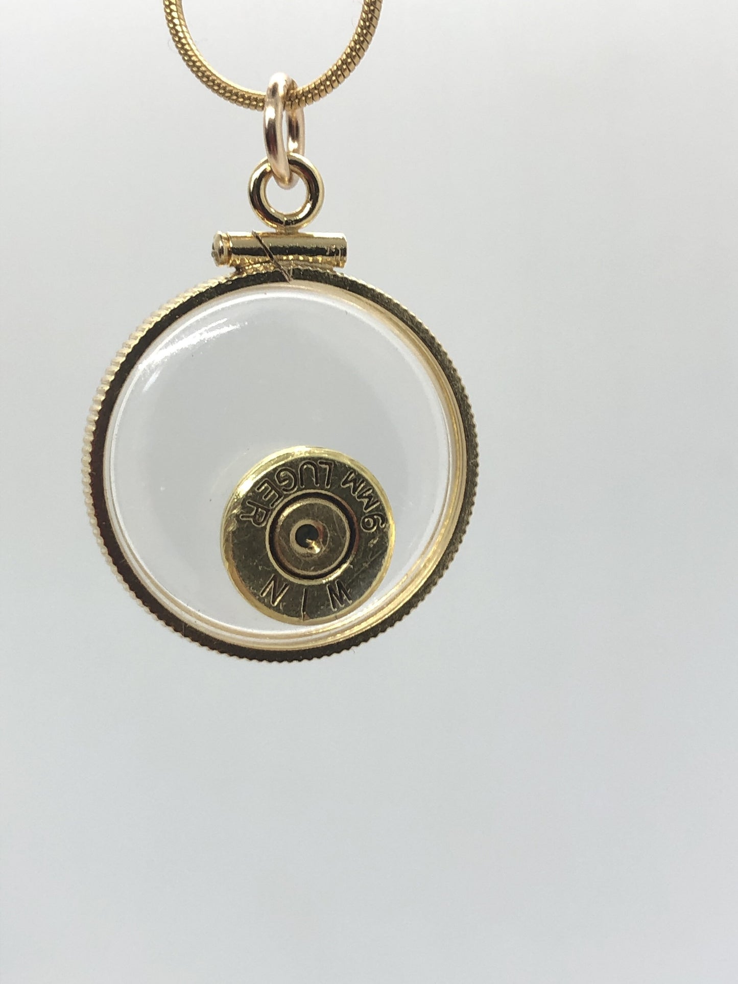9mm bullet necklace, back to back view locket, 14k gold filled one side fired primer, other Garnet gem