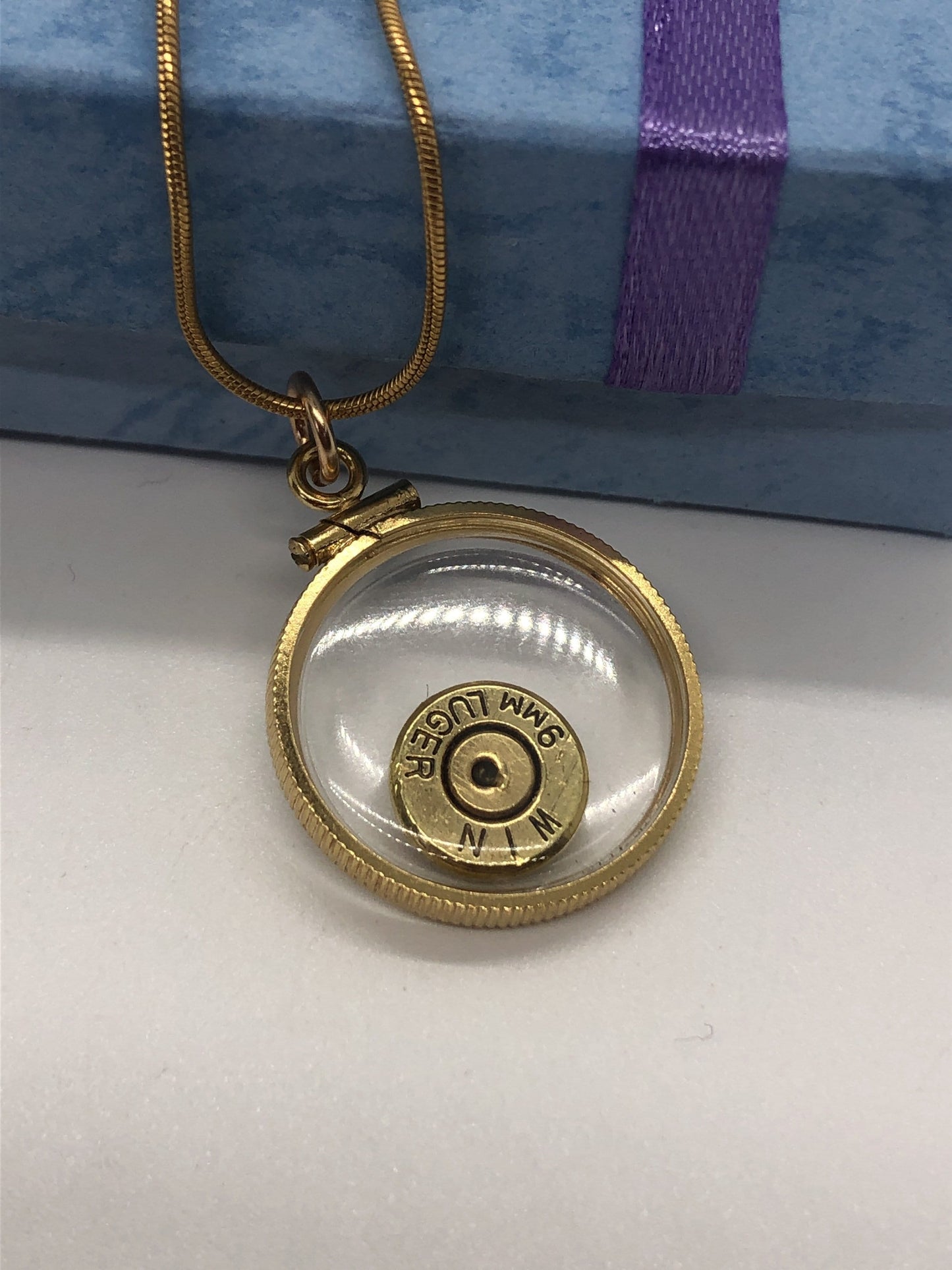 9mm bullet necklace, back to back view locket, 14k gold filled one side fired primer, other Garnet gem