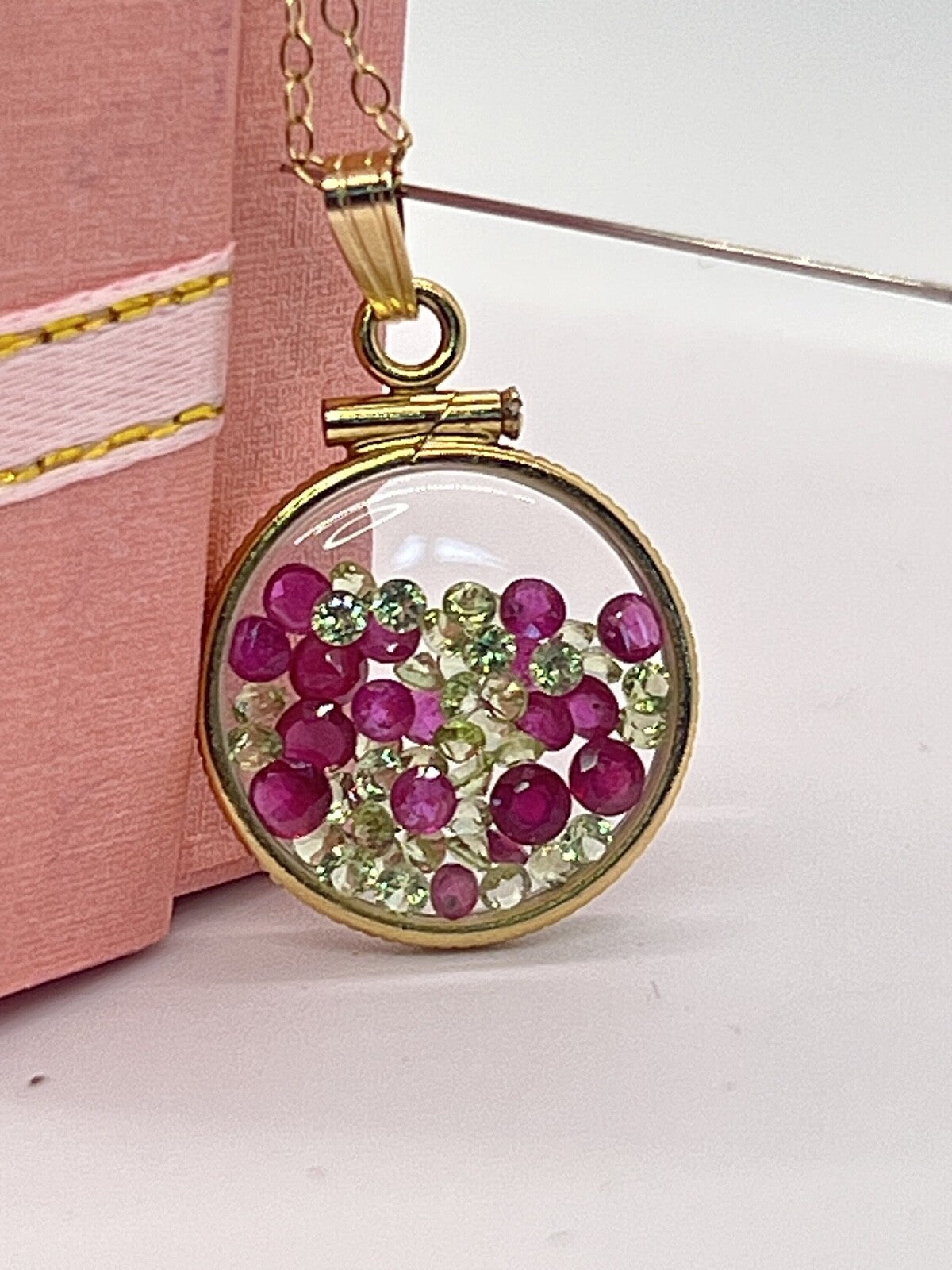14k gold filled dime size Lucite Shaker Locket with Rubies and Peridot