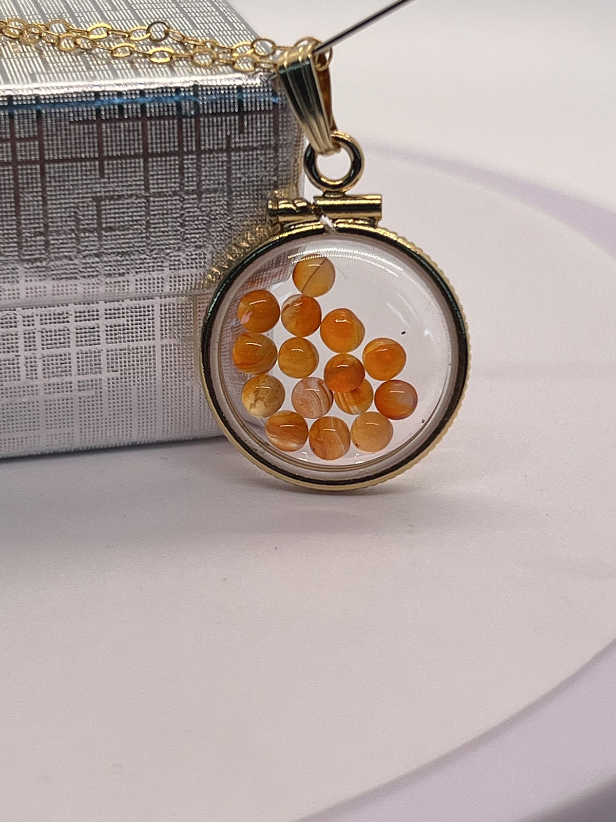 14k gold filled dime size Lucite Shaker Locket with Carnelian cabochons