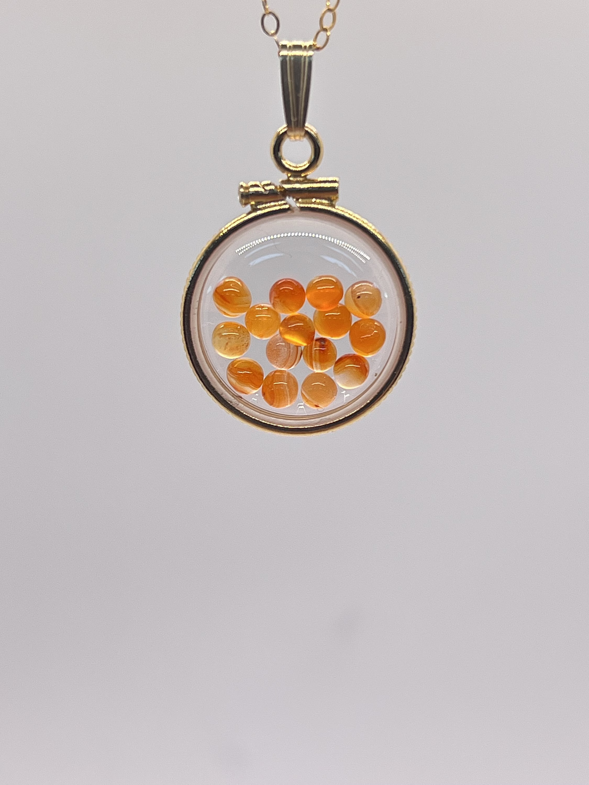 14k gold filled dime size Lucite Shaker Locket with Carnelian cabochons