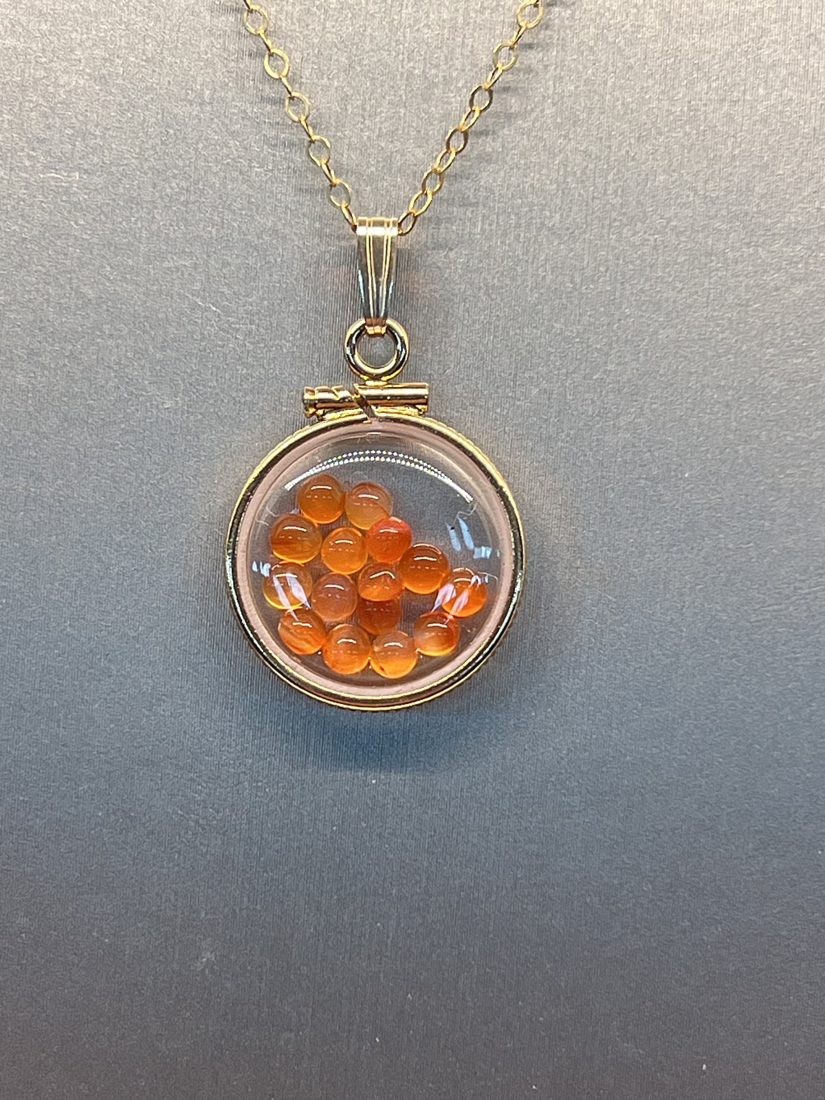14k gold filled dime size Lucite Shaker Locket with Carnelian cabochons