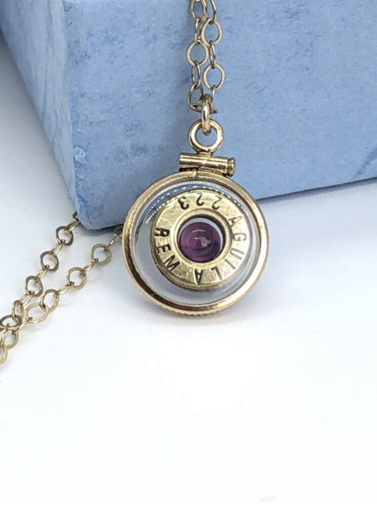 Handmade 14k gold filled .223 cal bullet view locket, with a genuine garnet
