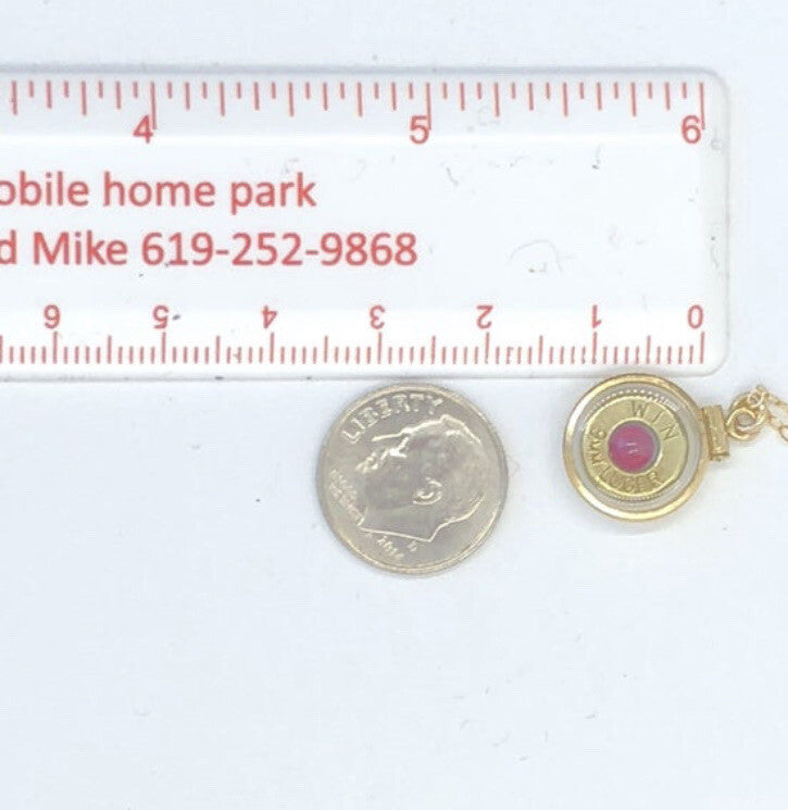 Handmade 14k gold filled .223 cal bullet view locket, with a genuine garnet