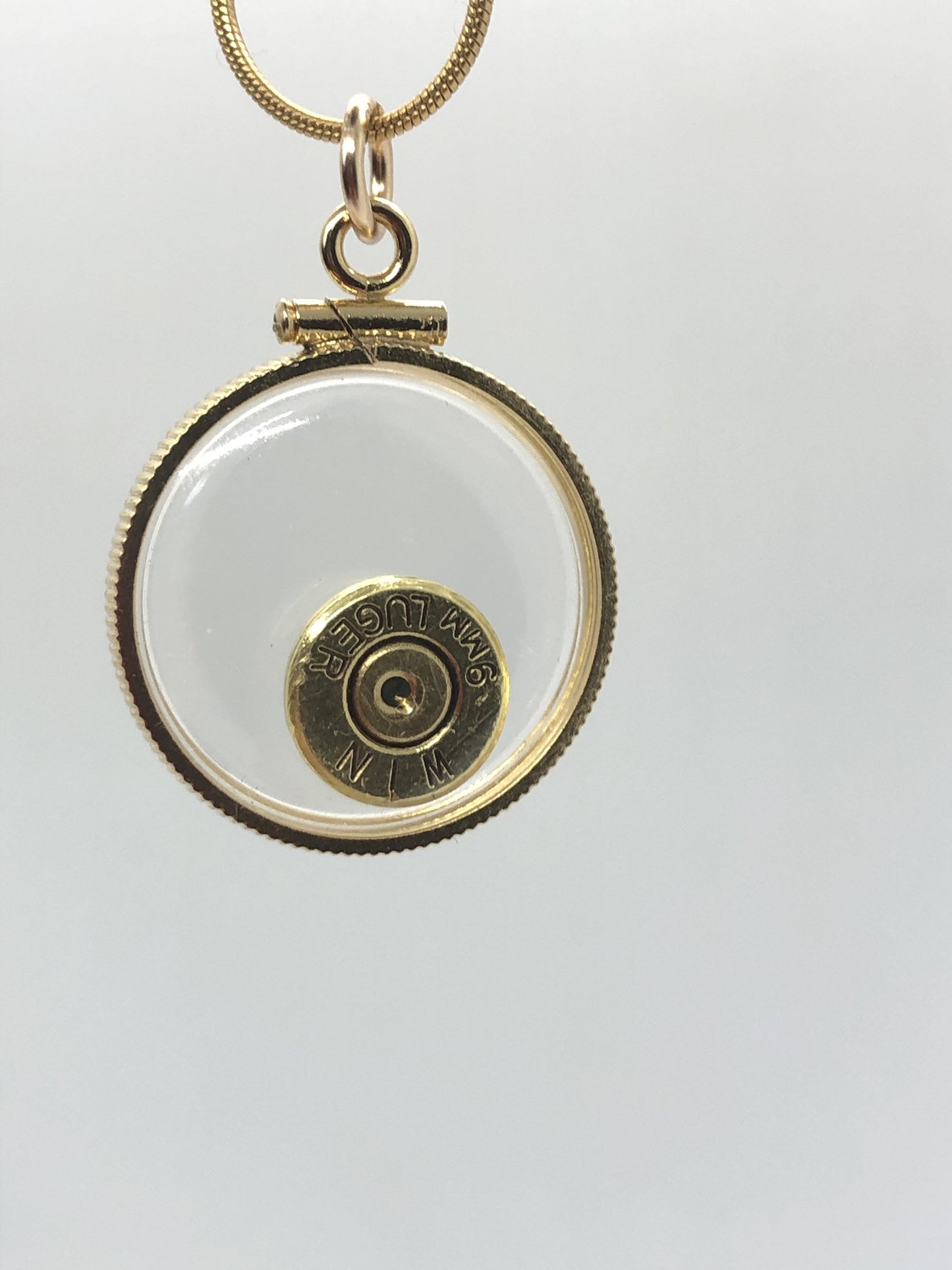 9mm bullet necklace, back to back view locket, 14k gold filled one side fired primer, other Garnet gem