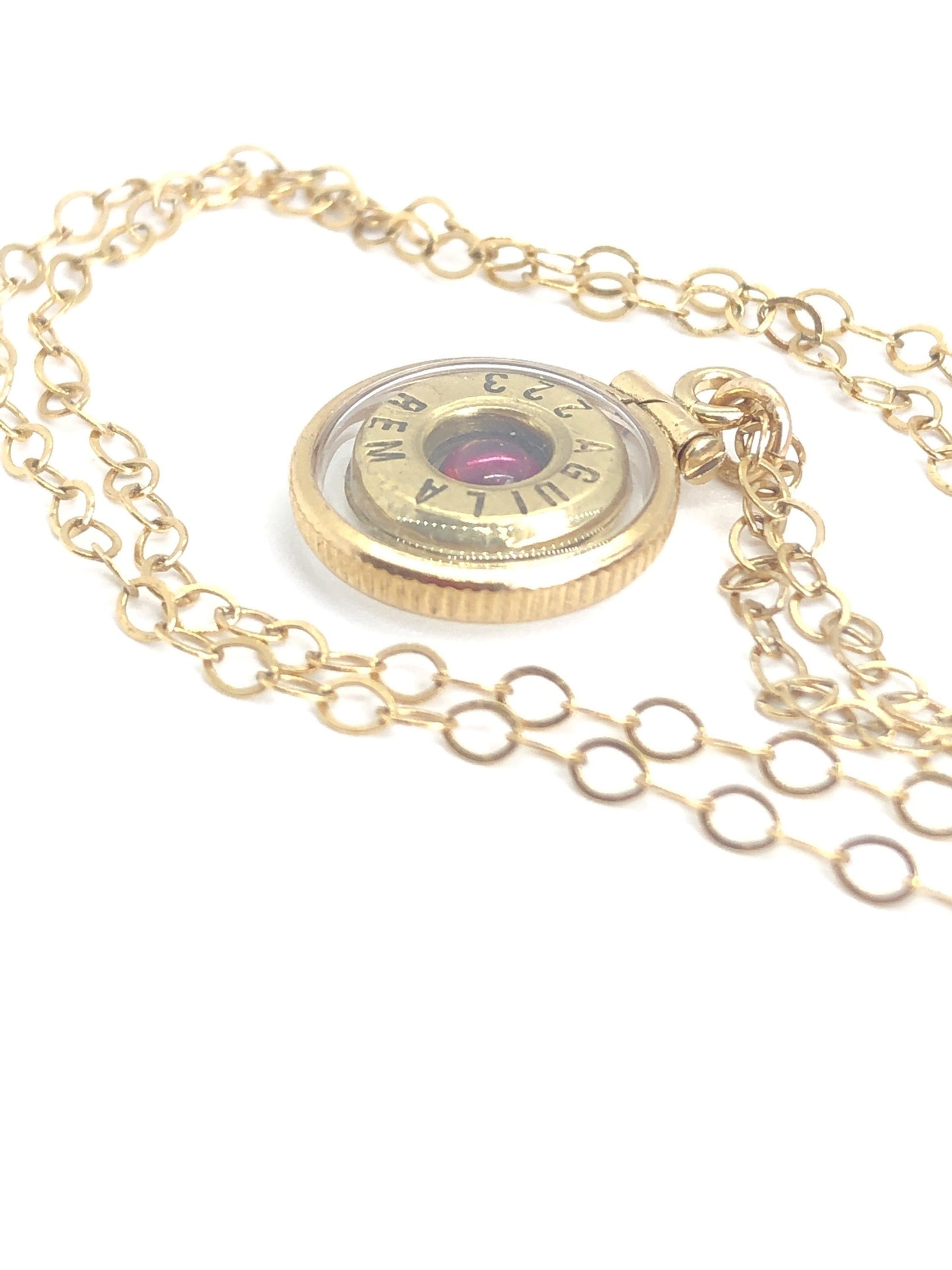 Handmade 14k gold filled .223 cal bullet view locket, finished with a 4mm genuine garnet gemstone, view from both sides