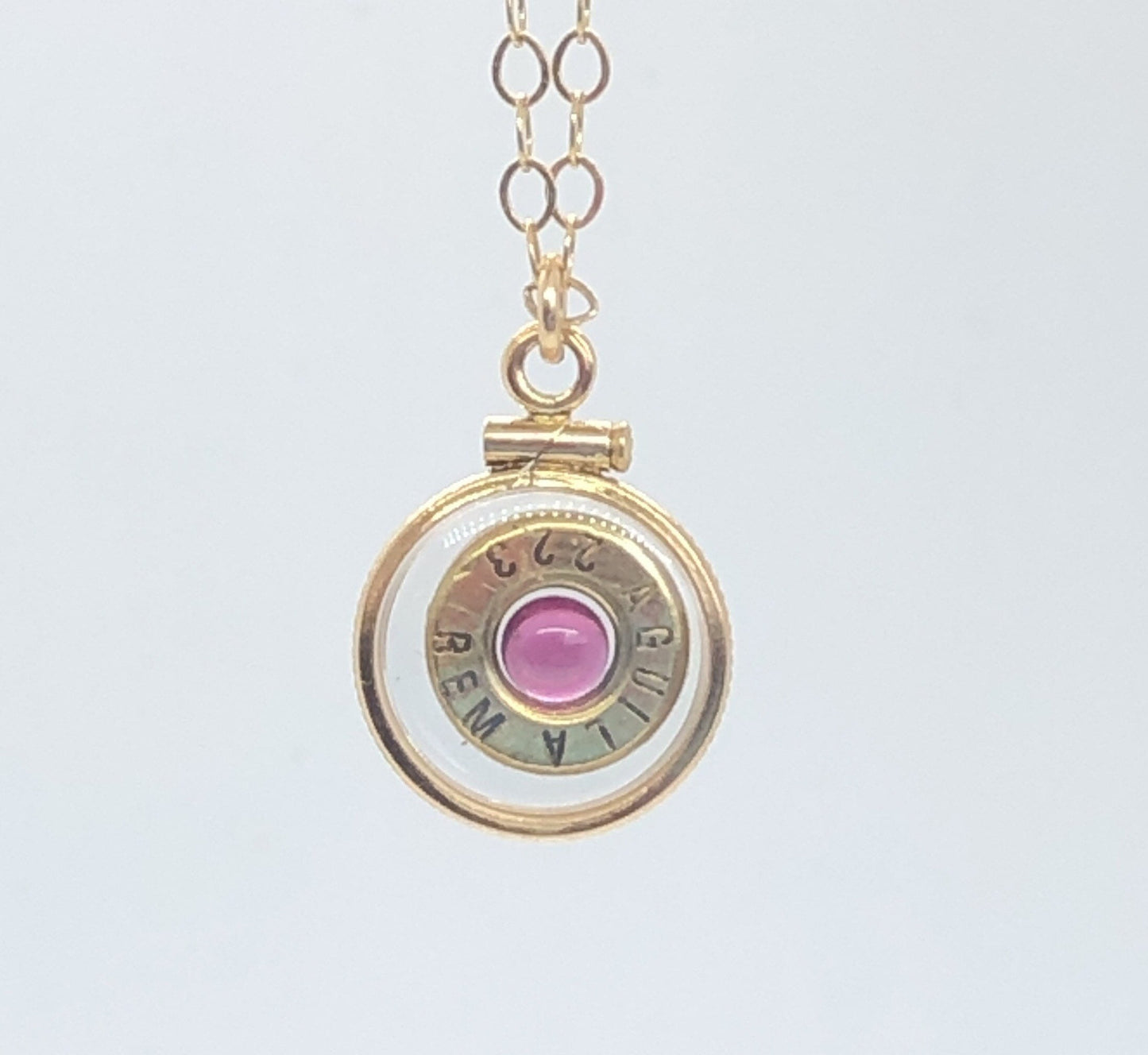 Handmade 14k gold filled .223 cal bullet view locket, finished with a 4mm genuine garnet gemstone, view from both sides