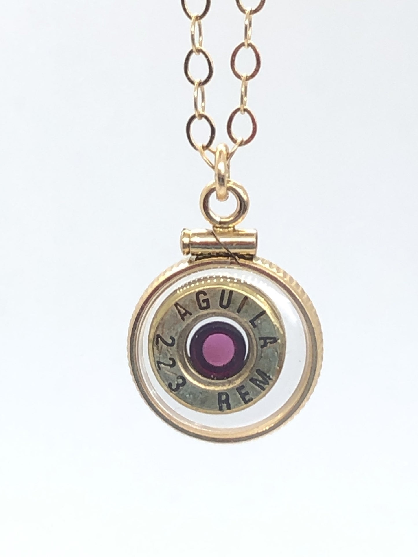 Handmade 14k gold filled .223 cal bullet view locket, finished with a 4mm genuine garnet gemstone, view from both sides