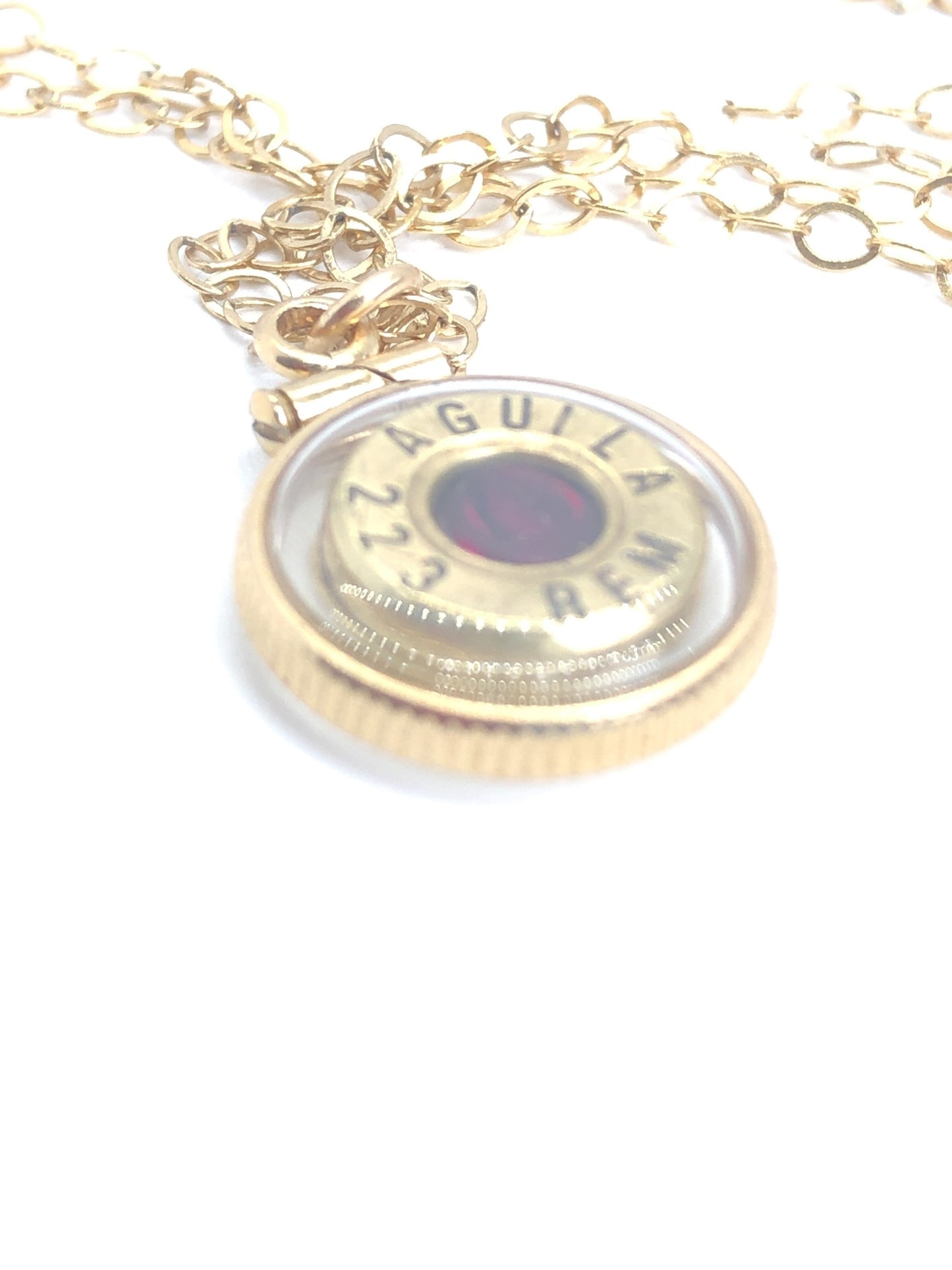 Handmade 14k gold filled .223 cal bullet view locket, finished with a 4mm genuine garnet gemstone, view from both sides