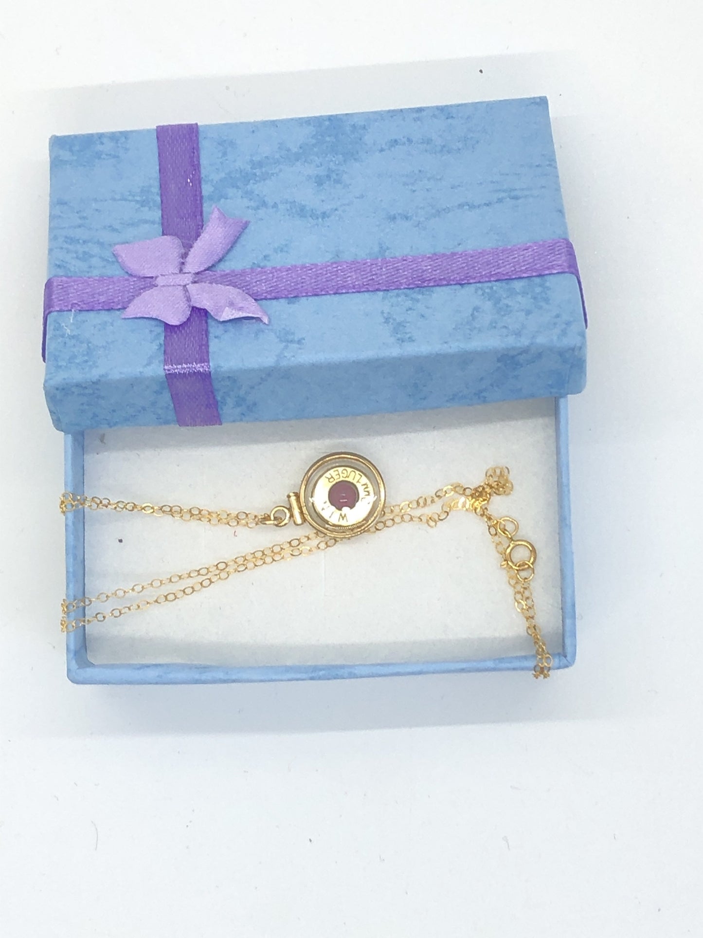 Handmade 14k gold filled .223 cal bullet view locket, finished with a 4mm genuine garnet gemstone, view from both sides