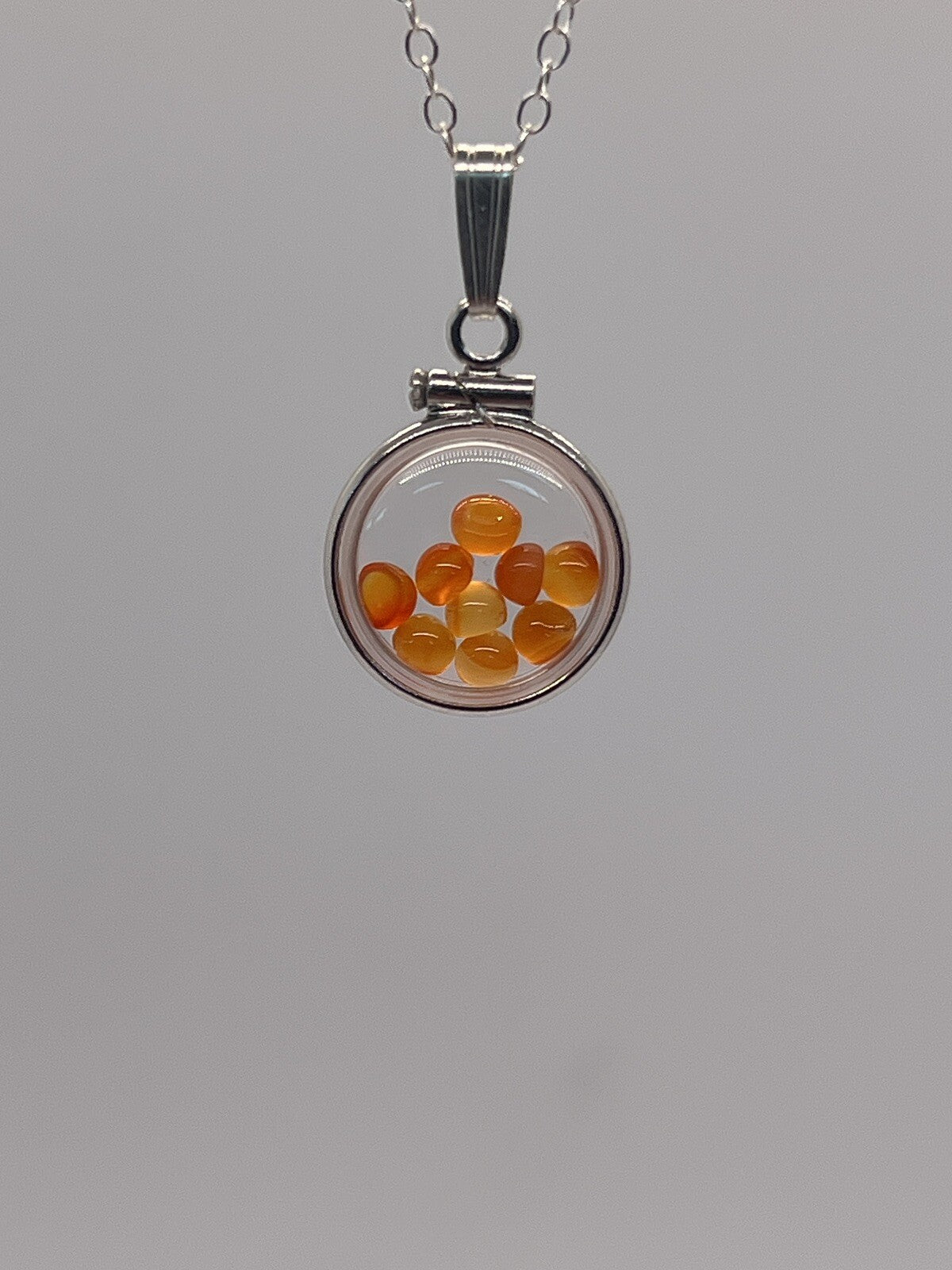 Diminutive Silver Carnelian Shaker Locket Lucite, natural orange cabs. 1.25 TCW