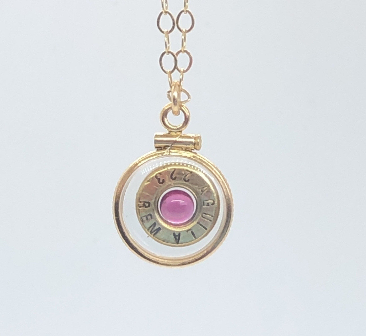 Handmade 14k gold filled .223 cal bullet view locket, finished with a 4mm genuine garnet gemstone, view from both sides