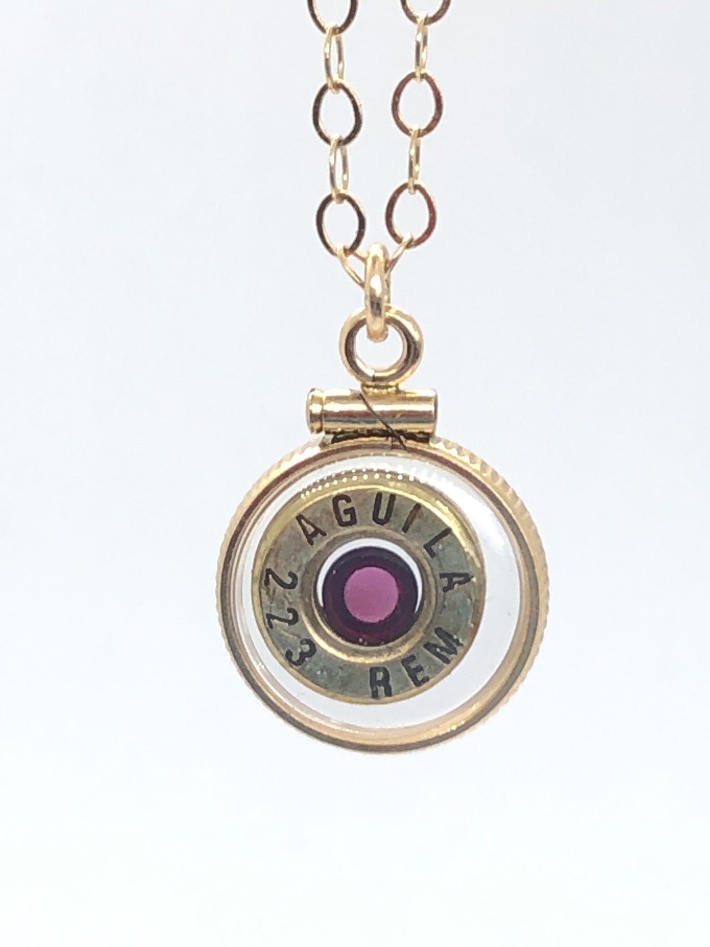 Handmade 14k gold filled .223 cal bullet view locket, finished with a 4mm genuine garnet gemstone, view from both sides
