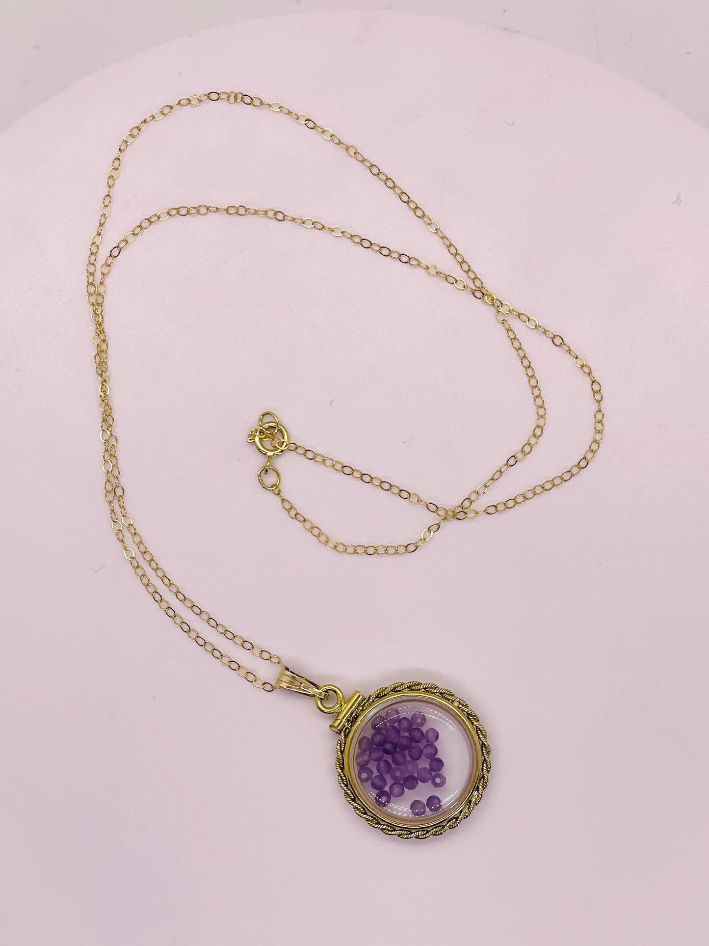 Hand made 21 mm nickel size 14k gold filled lucite genuine amethyst shaker locket with rope edge and beautiful bead crystals.