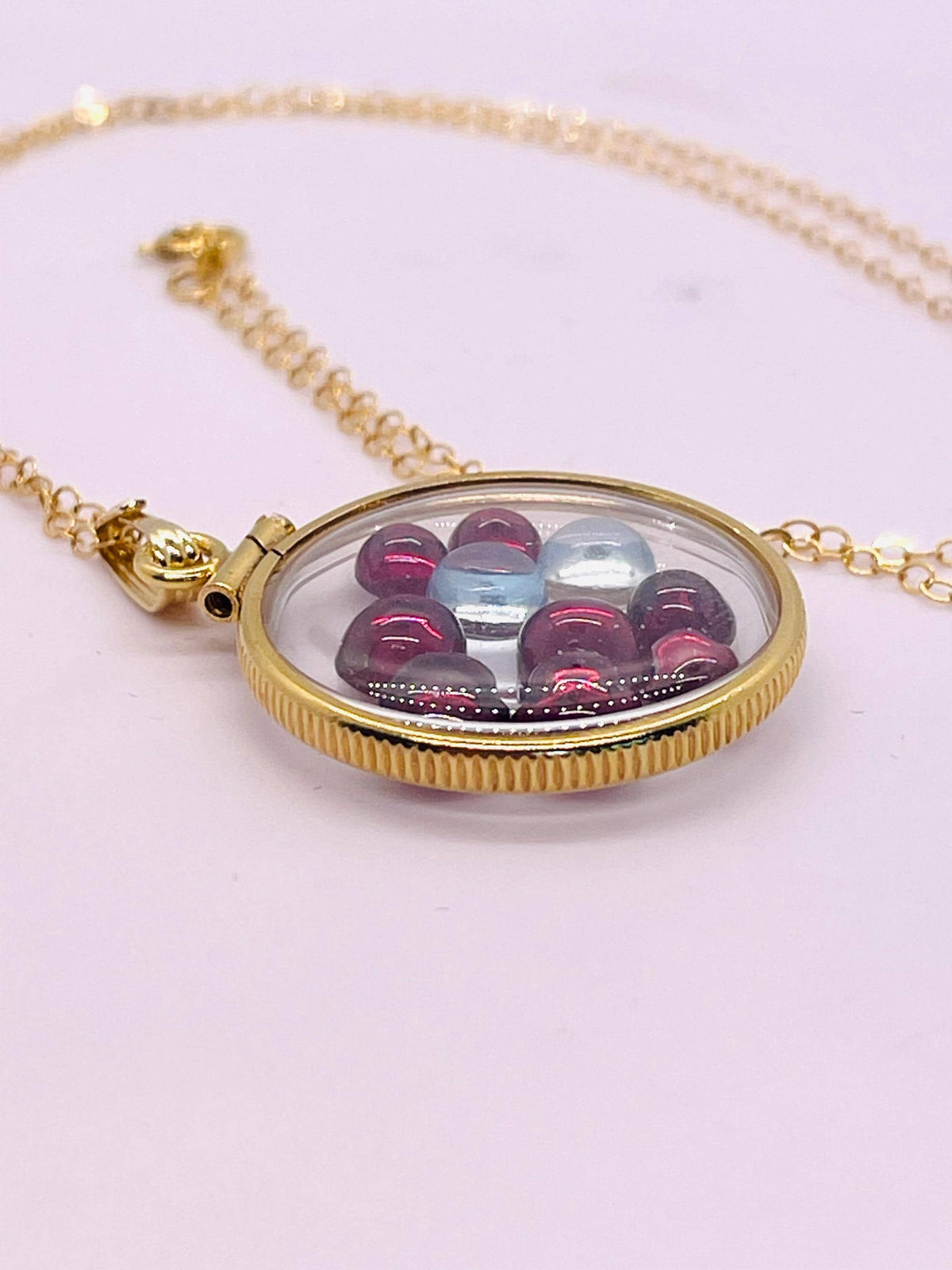 14k solid gold 22 mm handmade shaker locket filled with garnet and white topaz