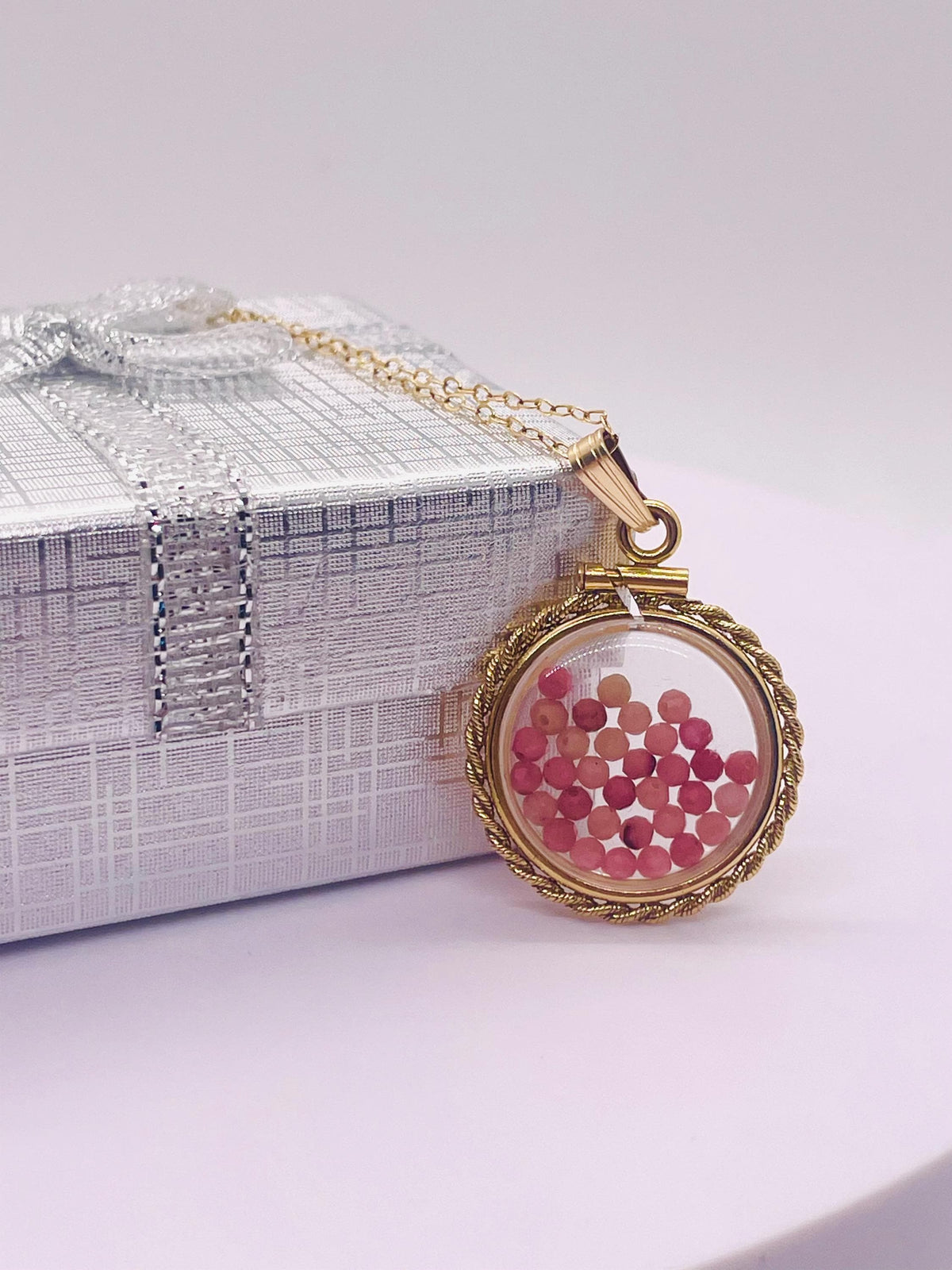 Hand made 21 mm nickel size 14k gold filled lucite genuine rhodonite shaker locket with rope edge and  beautiful bead crystals.