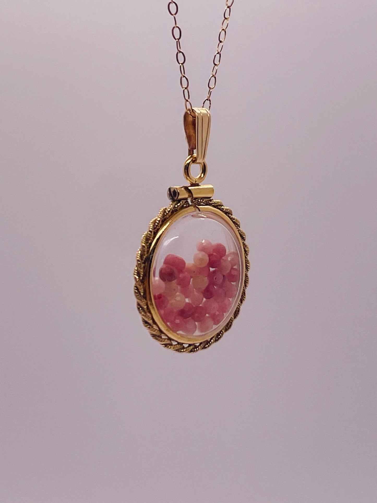 Hand made 21 mm nickel size 14k gold filled lucite genuine rhodonite shaker locket with rope edge and  beautiful bead crystals.