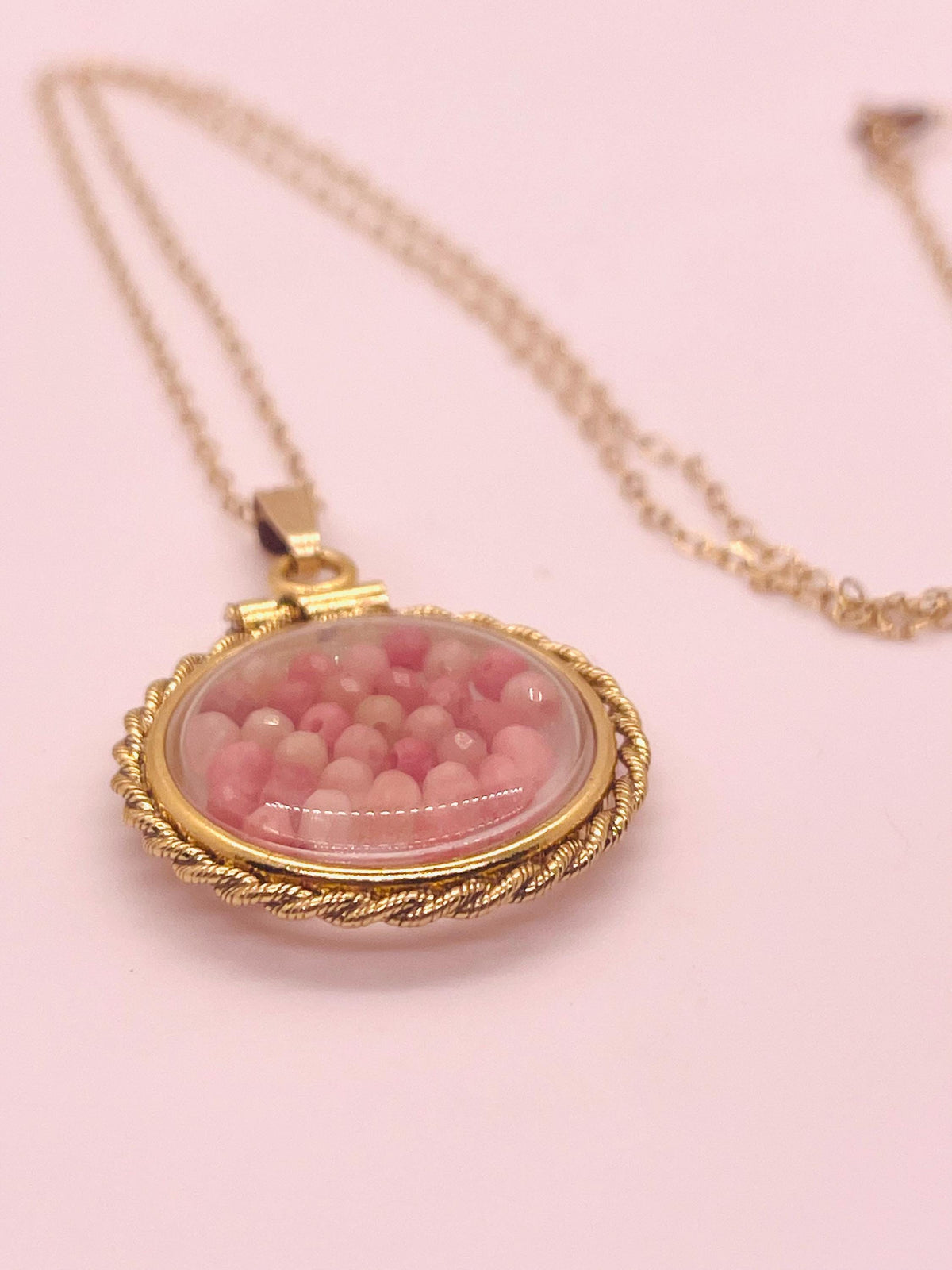Hand made 21 mm nickel size 14k gold filled lucite genuine rhodonite shaker locket with rope edge and  beautiful bead crystals.