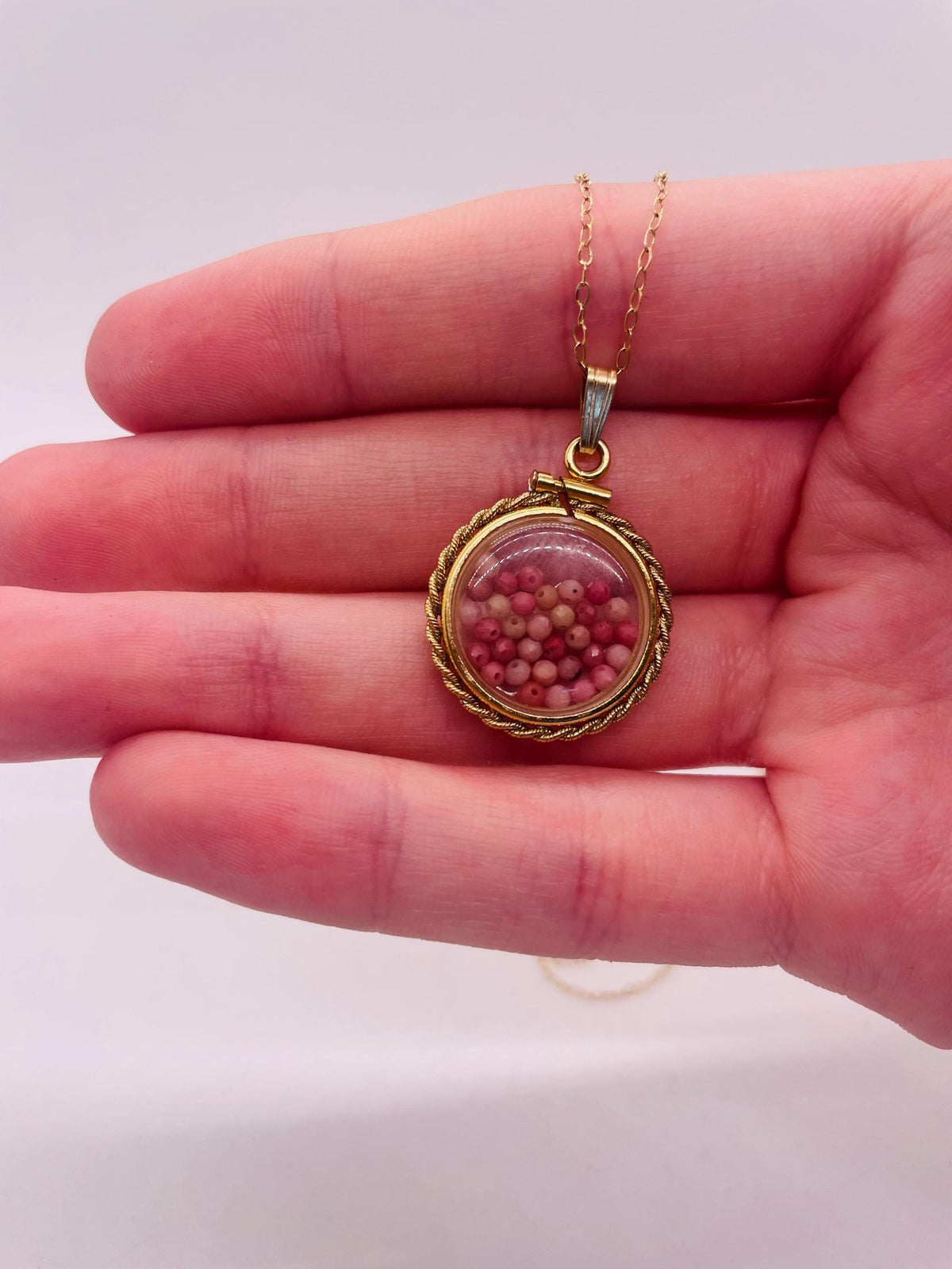 Hand made 21 mm nickel size 14k gold filled lucite genuine rhodonite shaker locket with rope edge and  beautiful bead crystals.