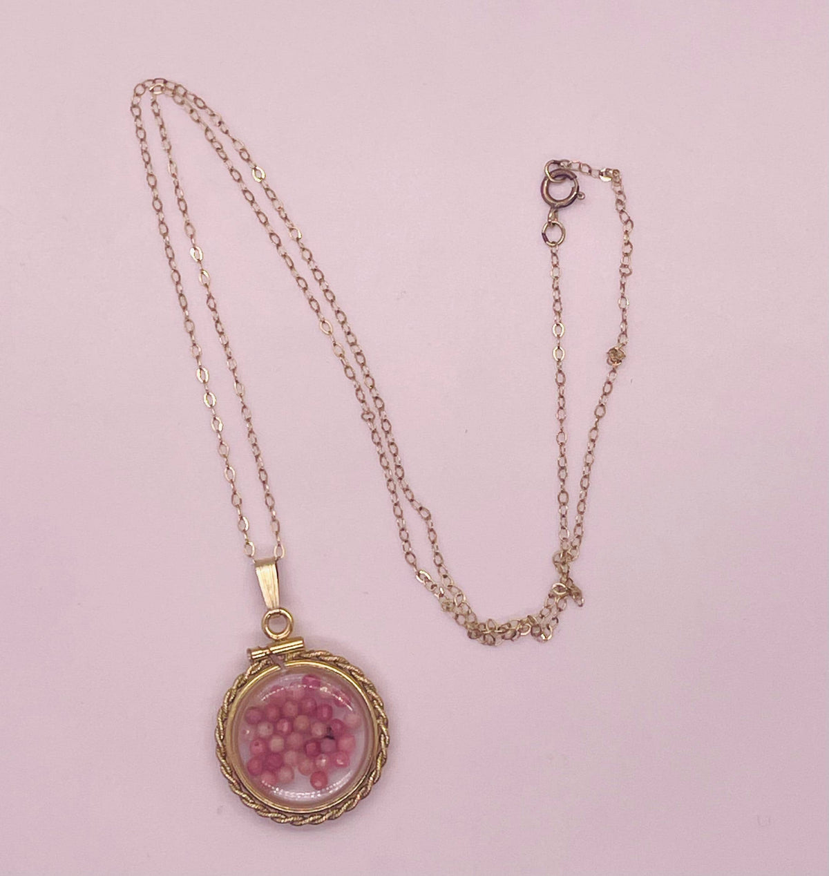 Hand made 21 mm nickel size 14k gold filled lucite genuine rhodonite shaker locket with rope edge and  beautiful bead crystals.