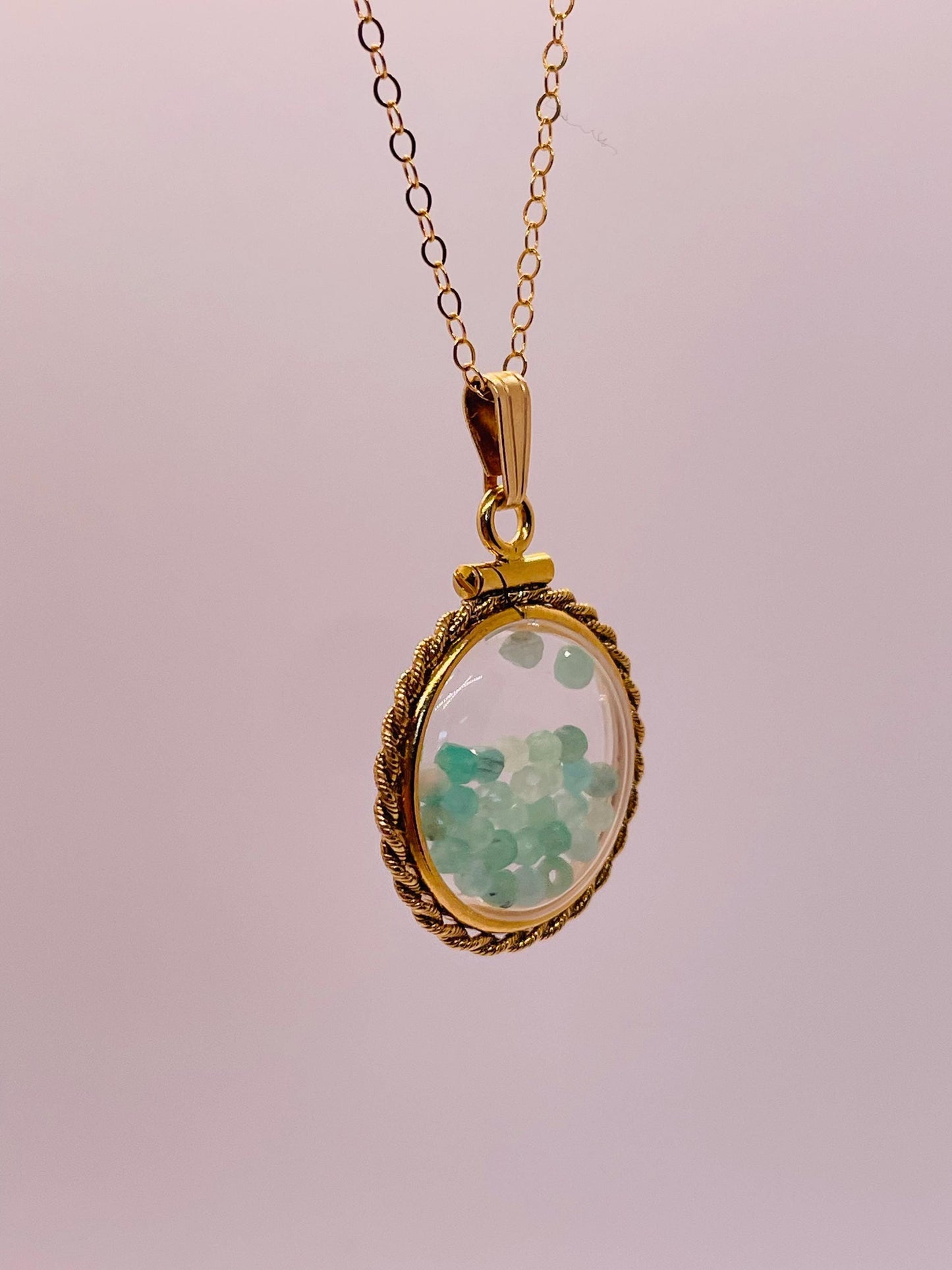 Hand made 21 mm nickel size 14k gold filled lucite genuine emerald shaker locket with rope edge and beautiful bead crystals.