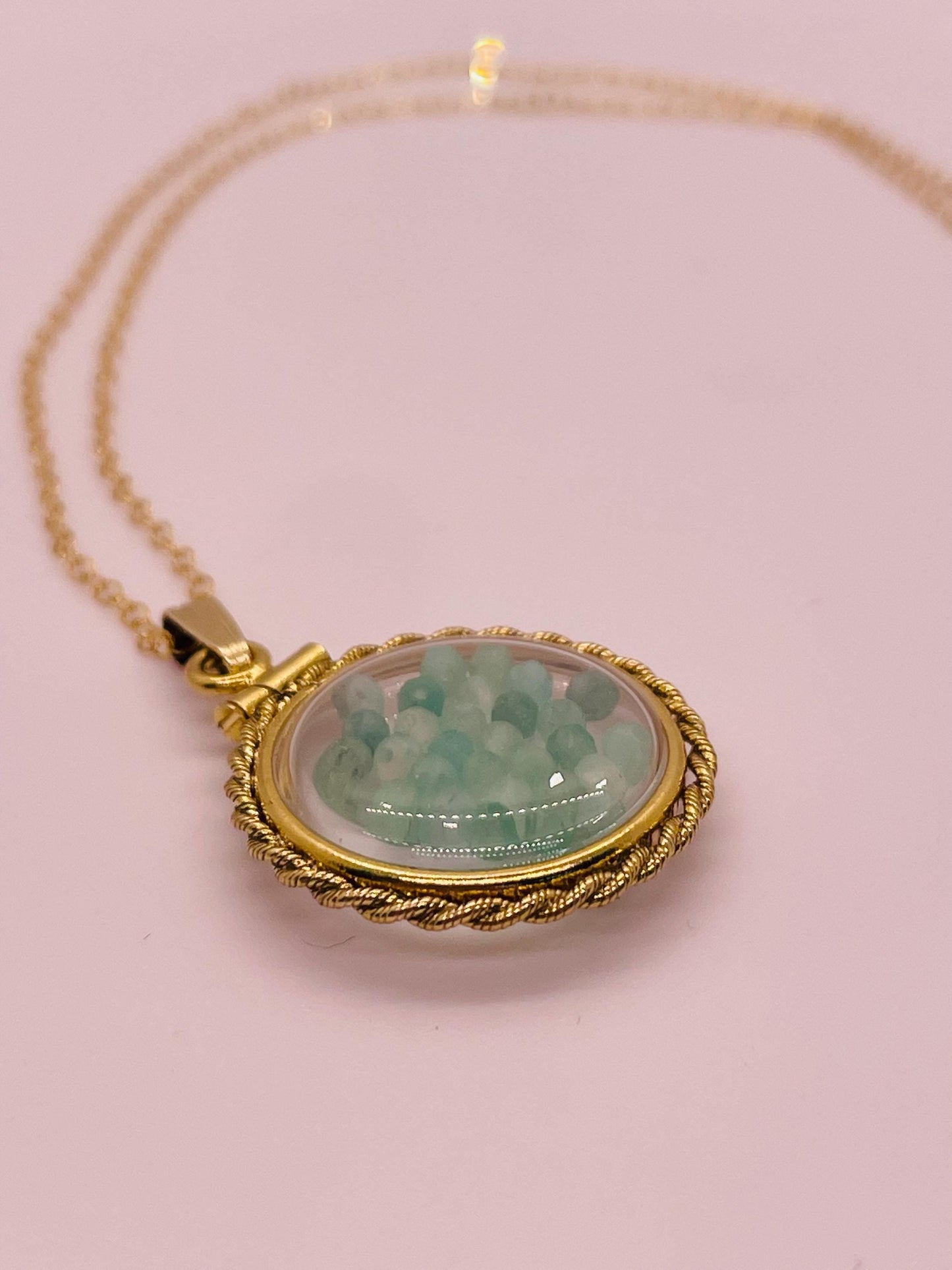 Hand made 21 mm nickel size 14k gold filled lucite genuine emerald shaker locket with rope edge and beautiful bead crystals.