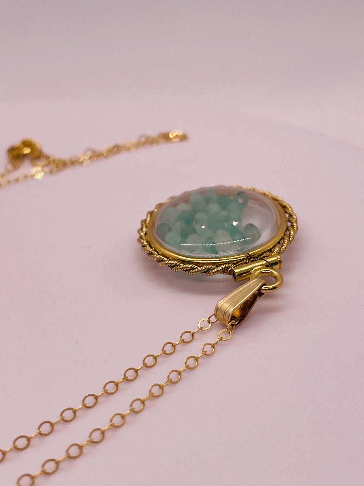 Hand made 21 mm nickel size 14k gold filled lucite genuine emerald shaker locket with rope edge and beautiful bead crystals.