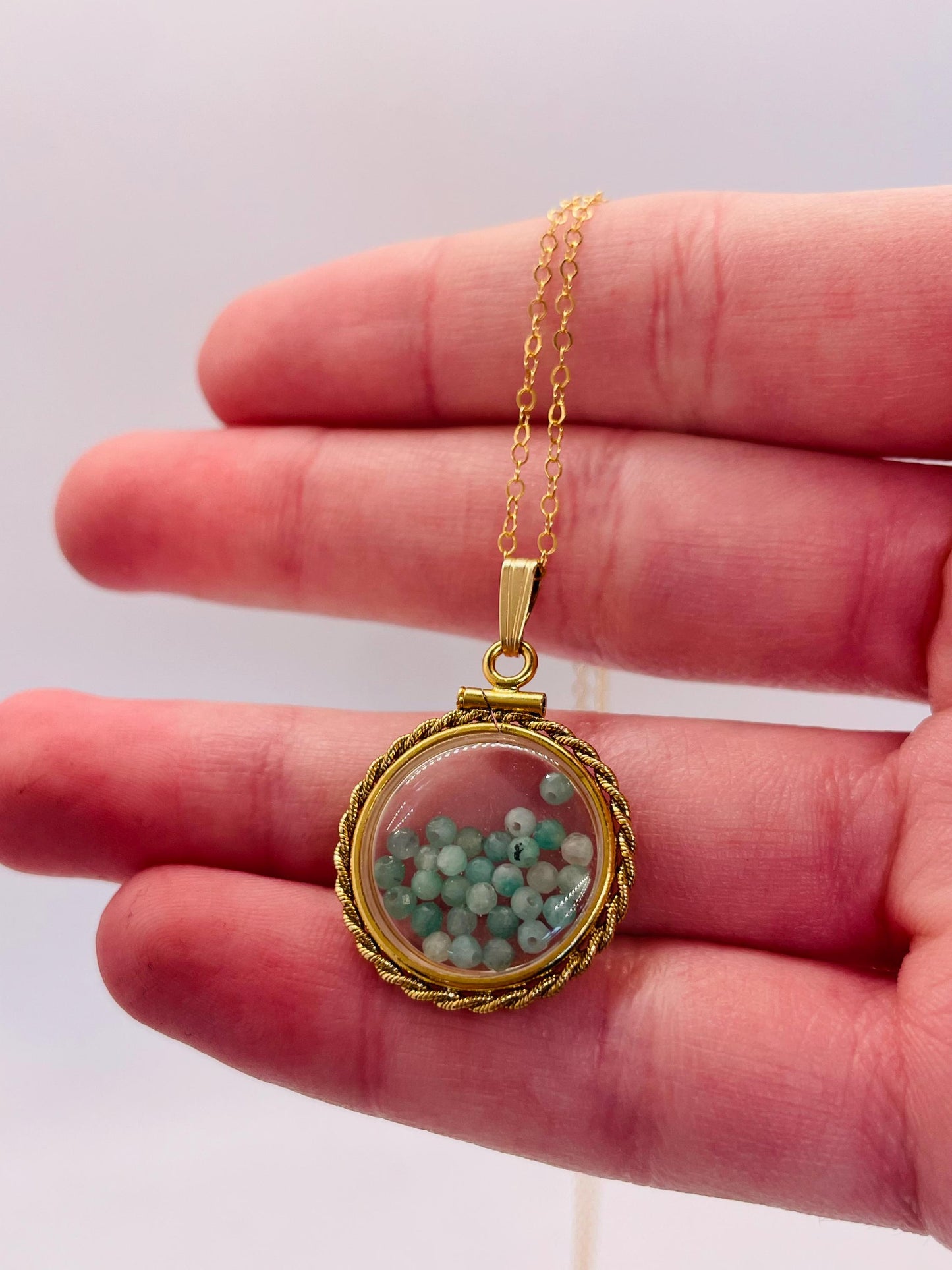 Hand made 21 mm nickel size 14k gold filled lucite genuine emerald shaker locket with rope edge and beautiful bead crystals.