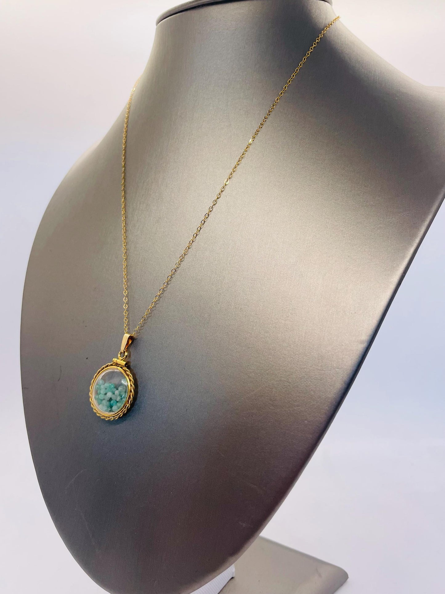 Hand made 21 mm nickel size 14k gold filled lucite genuine emerald shaker locket with rope edge and beautiful bead crystals.