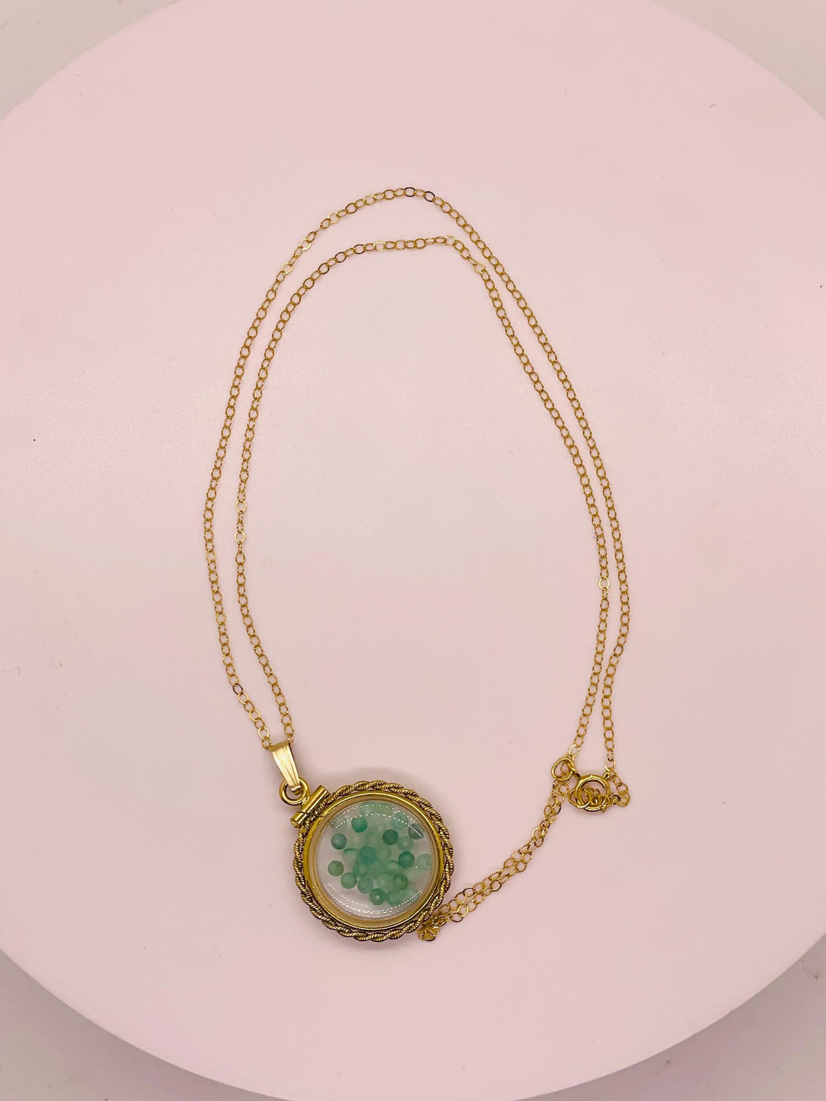 Hand made 21 mm nickel size 14k gold filled lucite genuine emerald shaker locket with rope edge and beautiful bead crystals.