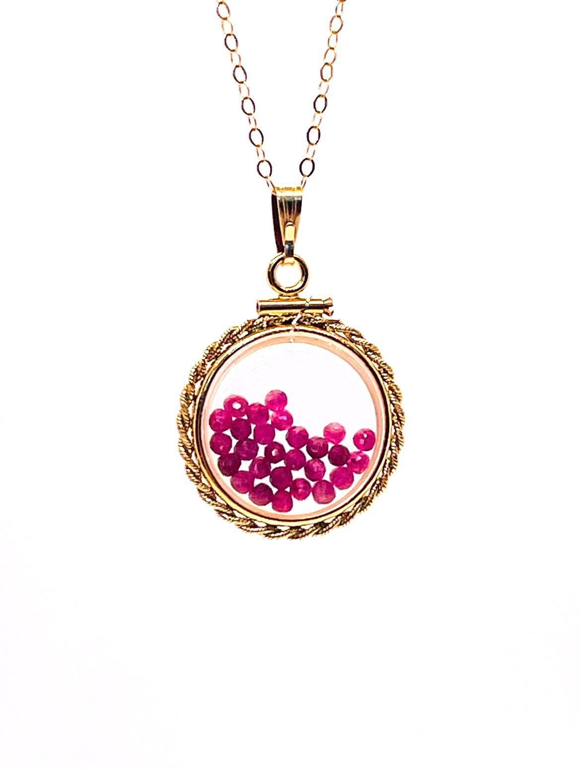 Hand made 21 mm nickel size 14k gold filled lucite genuine ruby shaker locket with rope edge and beautiful bead crystals.