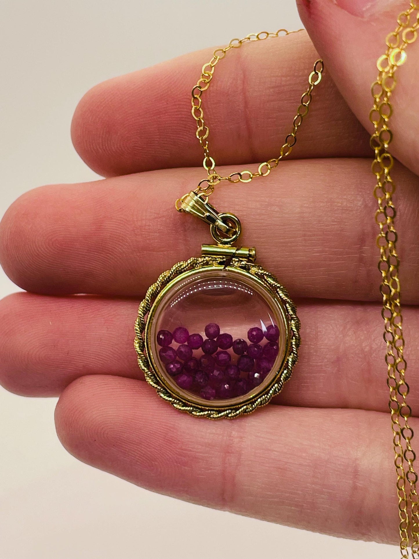 Hand made 21 mm nickel size 14k gold filled lucite genuine ruby shaker locket with rope edge and beautiful bead crystals.