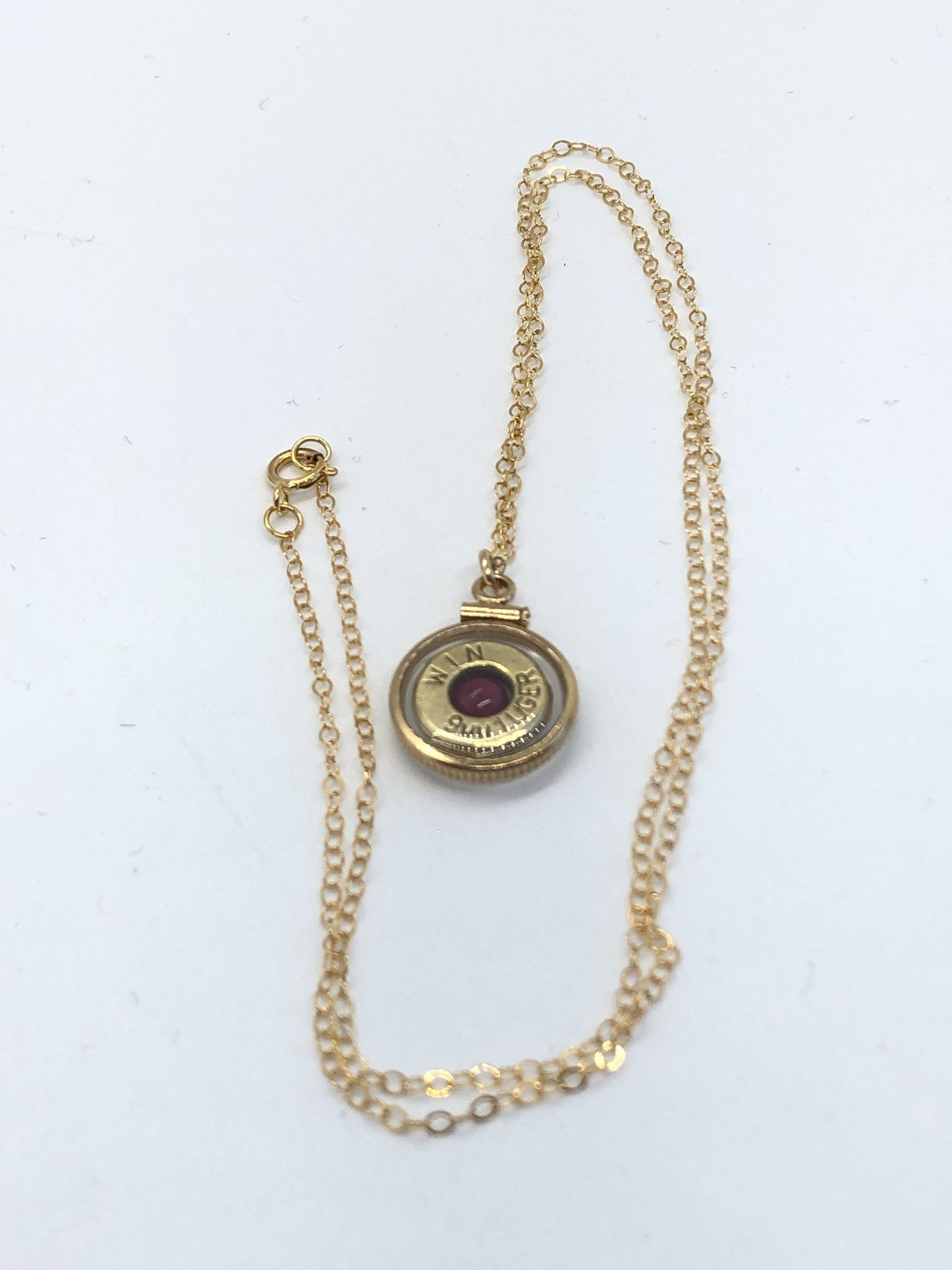 Handmade 14k gold filled 9mm bullet view locket, finished with a 4mm genuine garnet gemstone, view from both sides