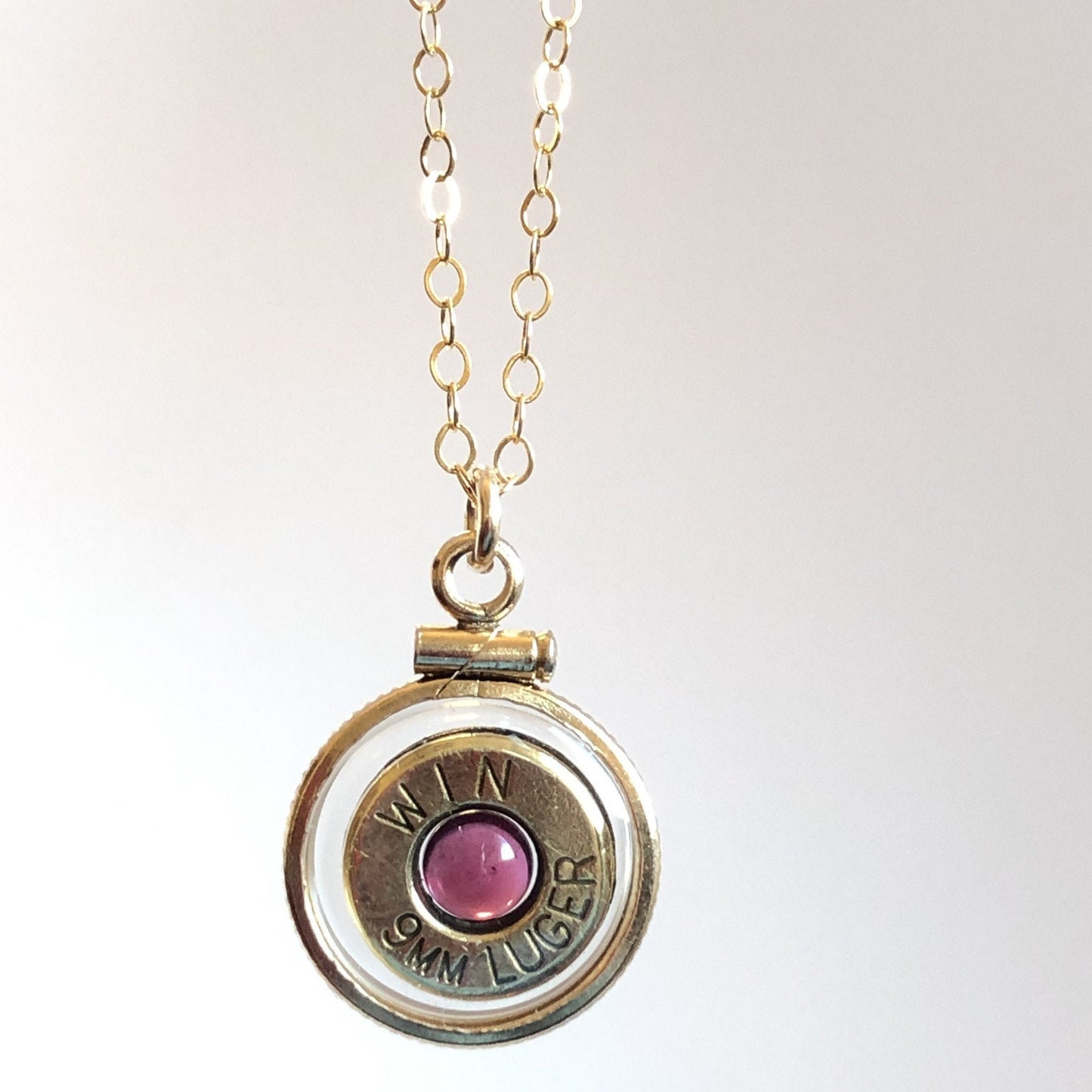 Handmade 14k gold filled 9mm bullet view locket, finished with a 4mm genuine garnet gemstone, view from both sides